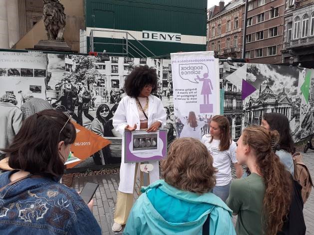 A female scientist talking to a crowd on a soapbox