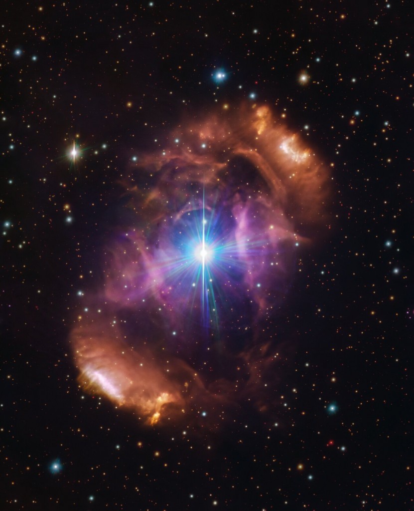 A blue bright star in space with an orange nebula cloud.  